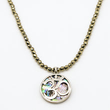 Cargar imagen en el visor de la galería, Collar de Hematita con dije de Concha con símbolo OM.