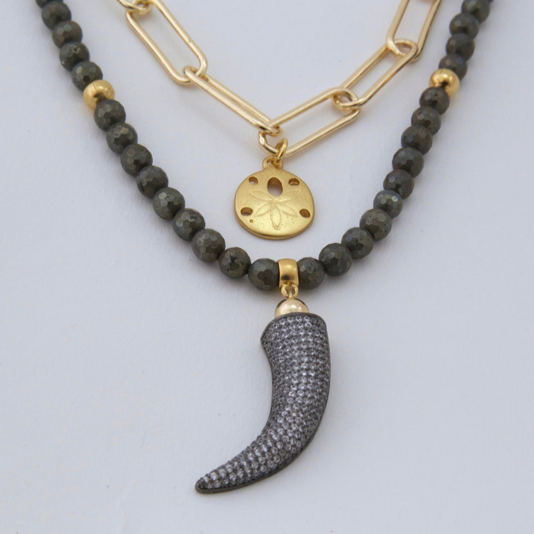 Double necklace with Pyrite and chain with Tusk and Sand dollar pendants. Matching earrings included.